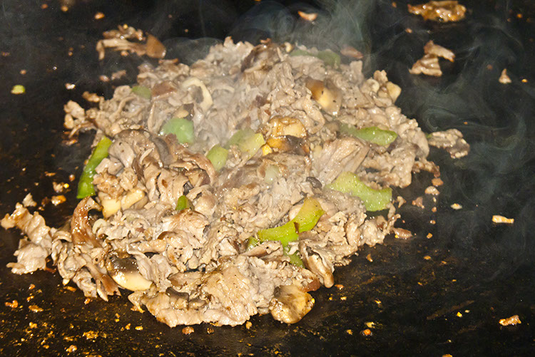 A big ol' pile of delicious sizzles and steams its way to ecstasy on the griddle.