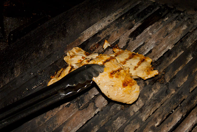 A perfectly plump chicken breast is plucked from the flame-broiler.